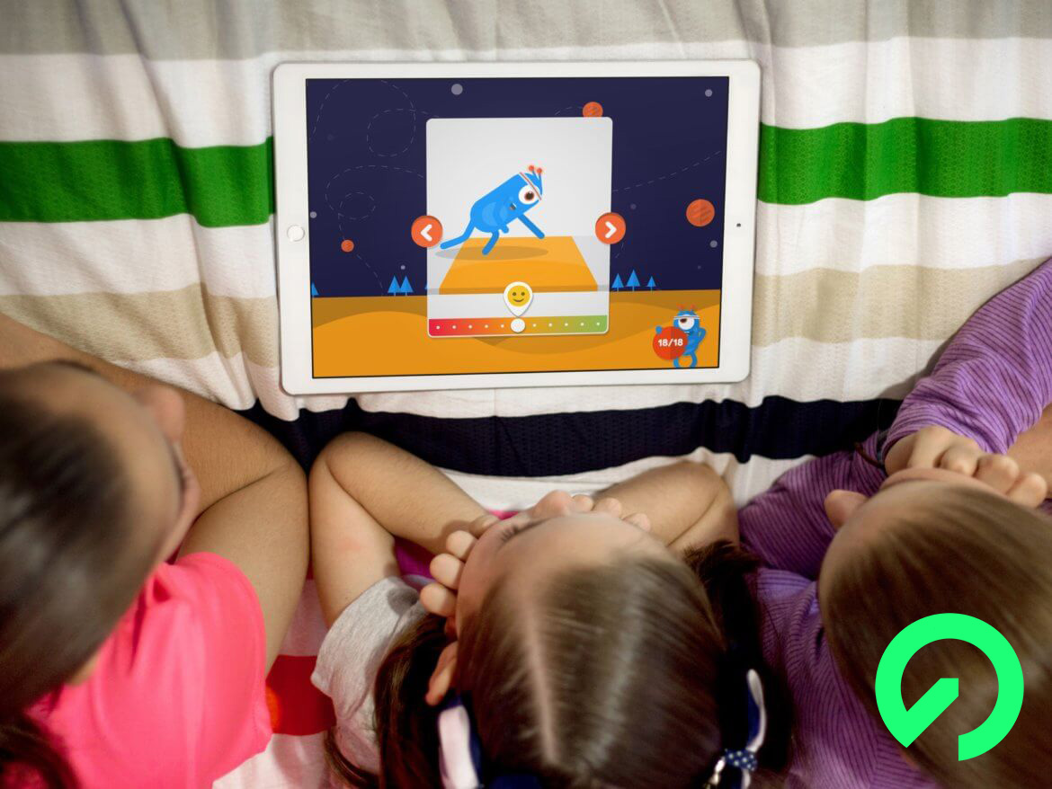 Three girls looking at an iPad where the I LIKE app is shown